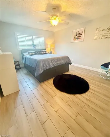 a bedroom with a bed and a lamp