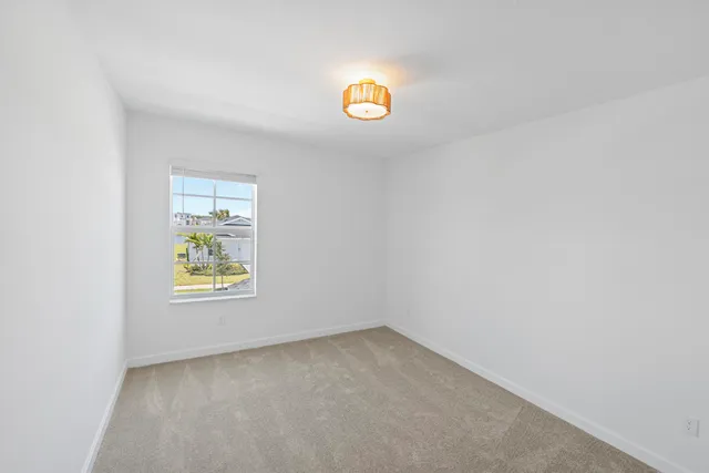 a view of an empty room and a window