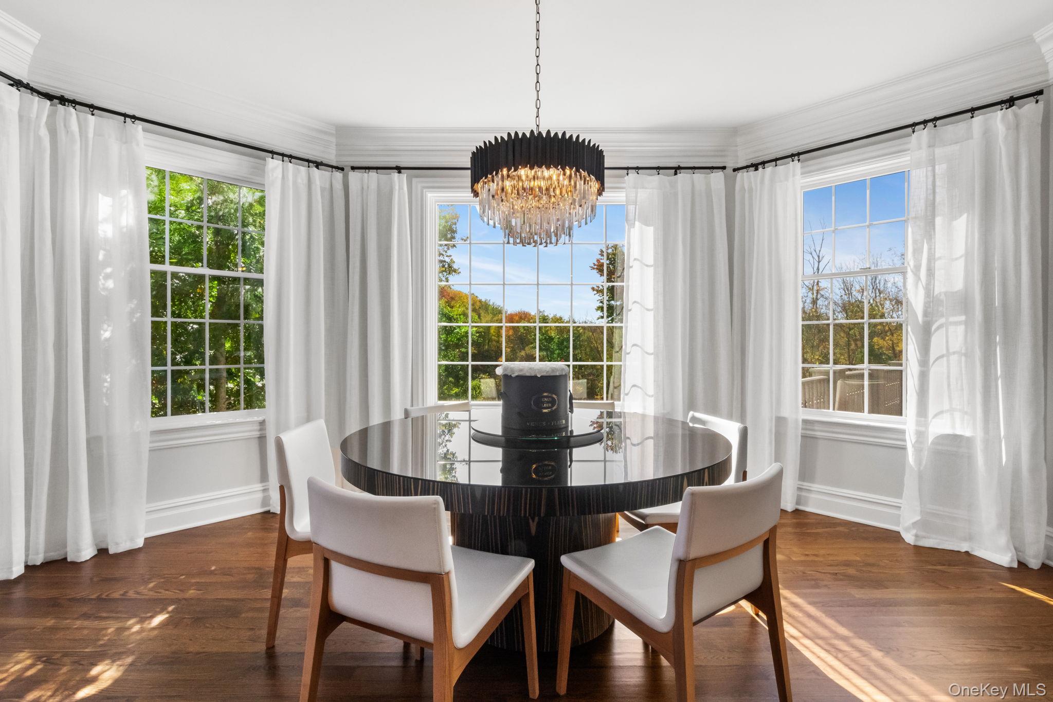 496 Long Ridge Road Bedford, NY 10576 - Photo 15 of 49 Dining area featuring a chandelier, dark wood finished floors, and crown molding