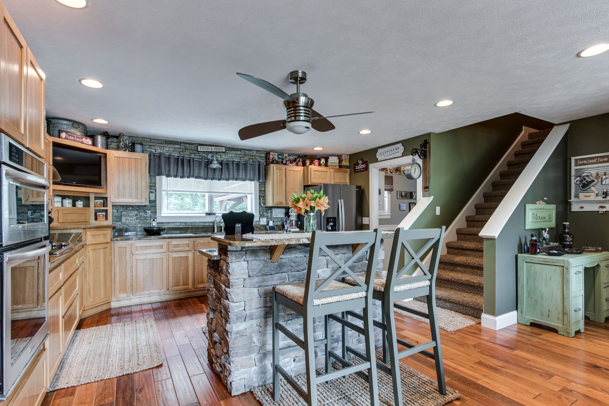 67 Cedar Bend Road Beechgrove, TN 37018 - Photo 11 of 48 a kitchen with stainless steel appliances granite countertop a kitchen island a stove a dining table and chairs