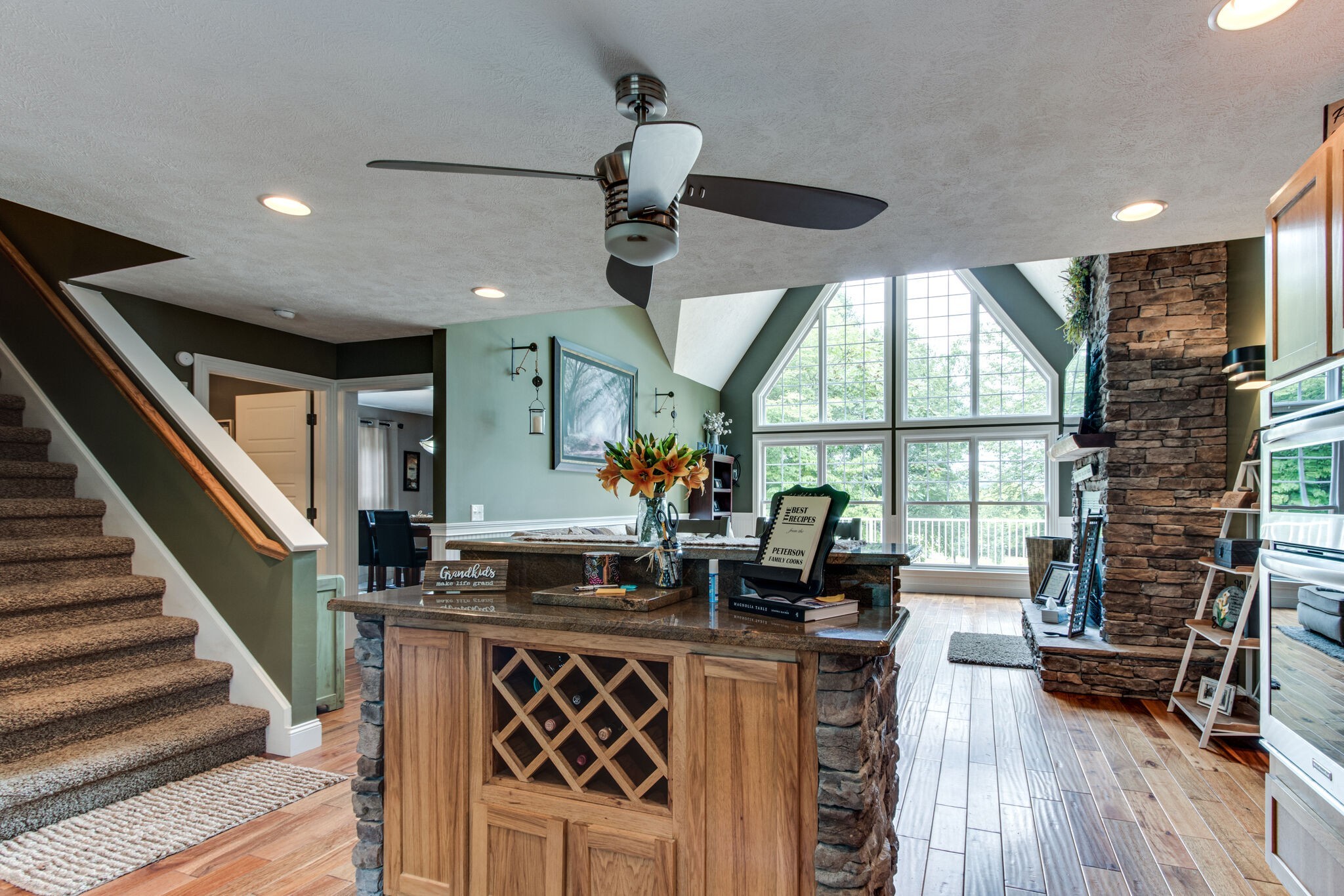67 Cedar Bend Road Beechgrove, TN 37018 - Photo 14 of 48 a kitchen with stainless steel appliances granite countertop a stove a refrigerator a sink a dining table and chairs with wooden floor