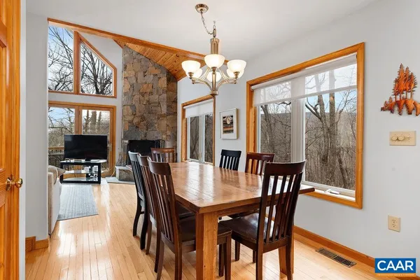 a kitchen with stainless steel appliances granite countertop wooden cabinets a stove a sink and a window