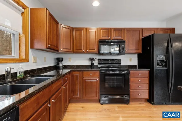 a kitchen that has a lot of furniture and a wooden floor