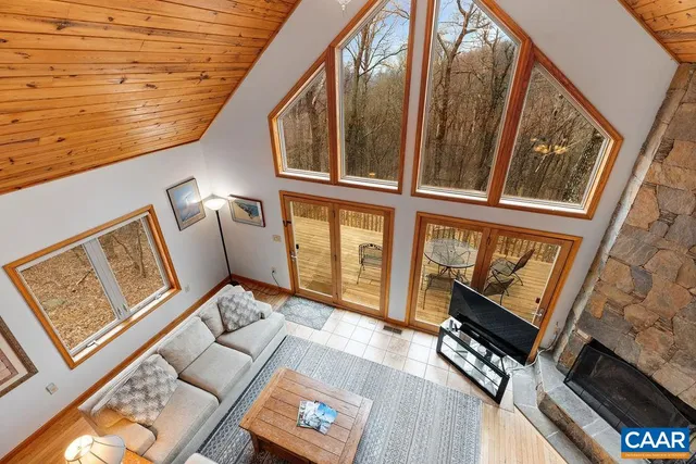 a spacious bedroom with a bed and a chandelier