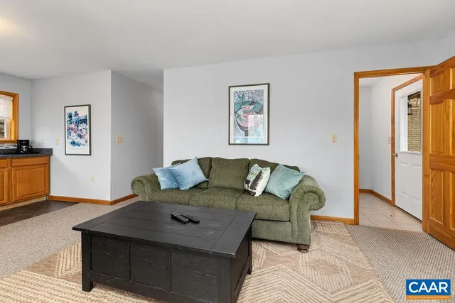 a bathroom with a granite countertop sink and a large mirror next to a window