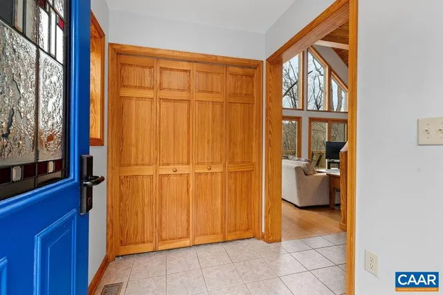 a living room with furniture and a floor to ceiling window