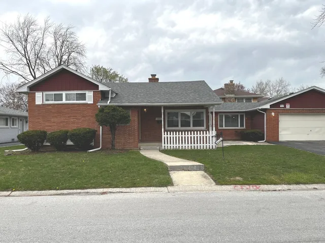 a view of an empty room with wooden floor fireplace and a window