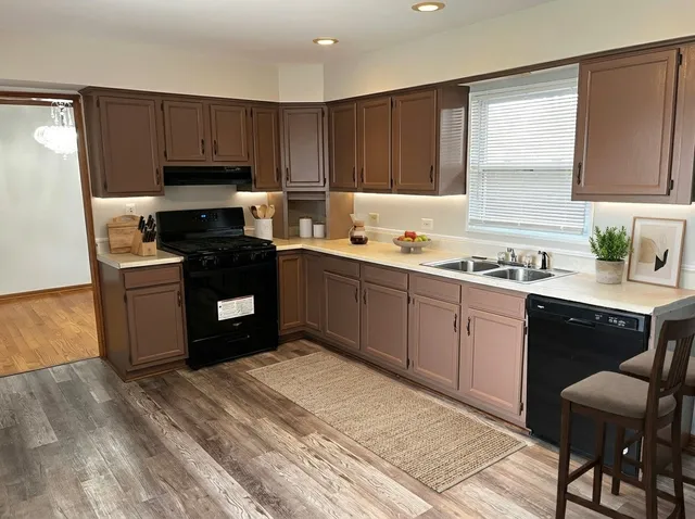 a bathroom with a granite countertop toilet sink and mirror
