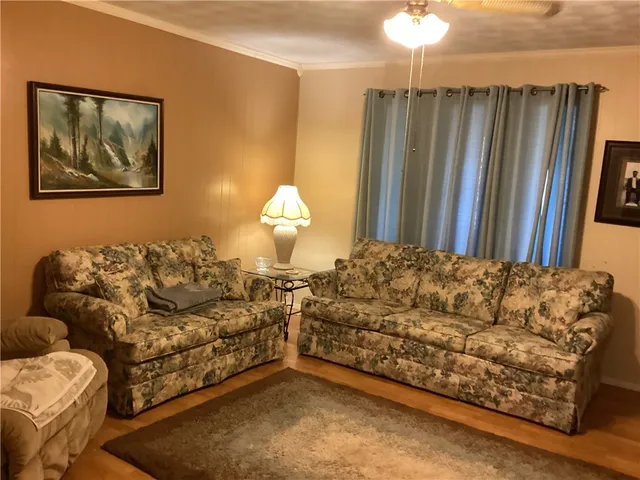 a living room with a couch and a chandelier