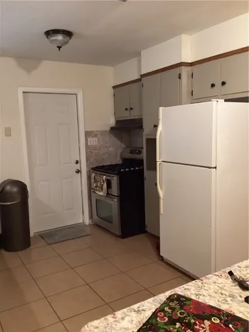 a kitchen with a refrigerator and a stove