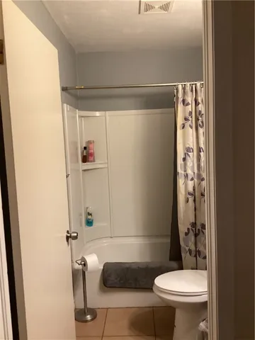 a bathroom with a shower and a toilet