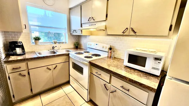 a kitchen with stainless steel appliances granite countertop a sink and a stove