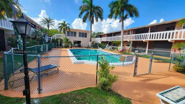 a view of a house with swimming pool and sitting area