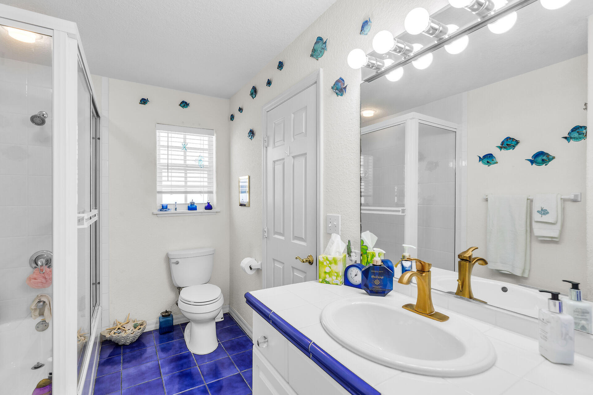 996 97th Street Marathon, FL 33050 - Photo 25 of 52 a bathroom with a sink a toilet and a mirror