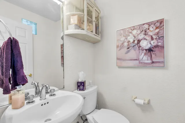 a view of a livingroom with furniture wooden floor and a chandelier