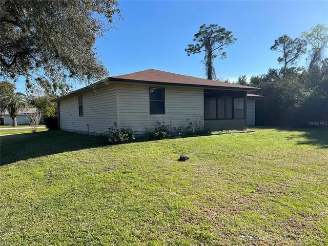 a front view of a house with a garden and yard