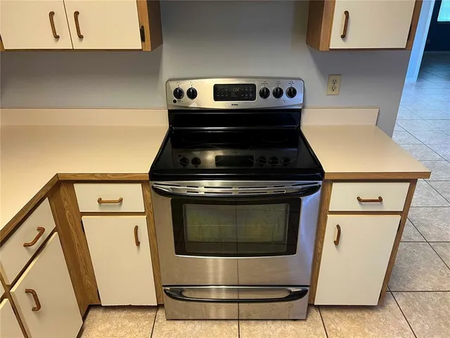 a stove top oven sitting inside of a kitchen