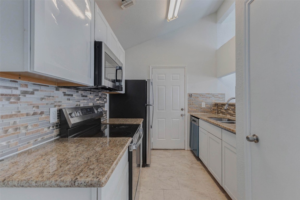 5210 Shirley Street Baytown, TX 77521 - Photo 11 of 31 a kitchen with a stove and a refrigerator