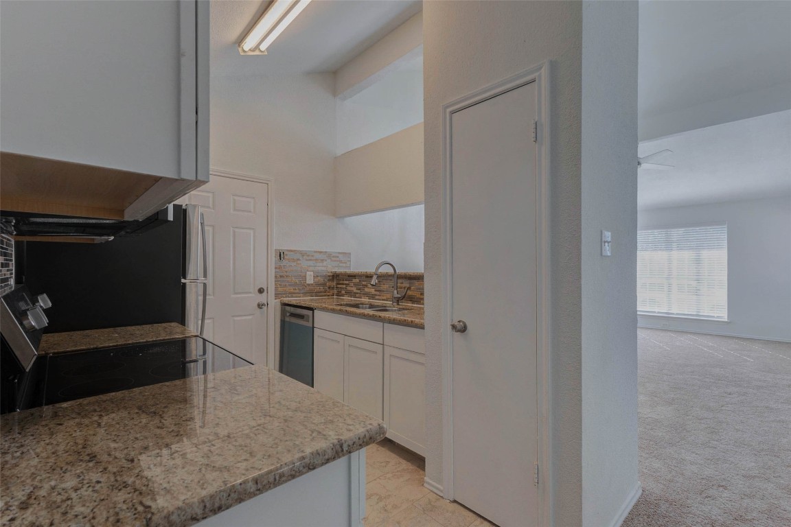 5210 Shirley Street Baytown, TX 77521 - Photo 12 of 31 a kitchen with a refrigerator and a stove top oven