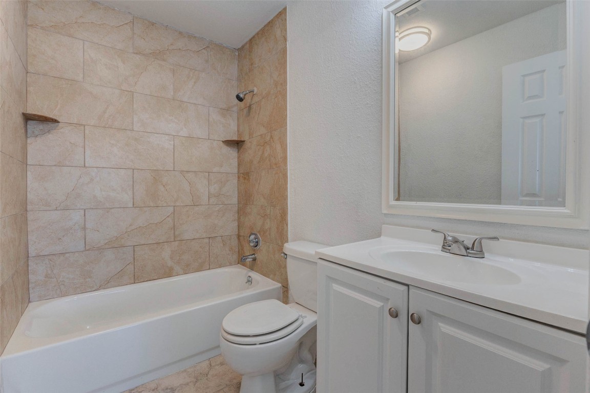 5210 Shirley Street Baytown, TX 77521 - Photo 18 of 31 a bathroom with a sink a toilet and bathtub