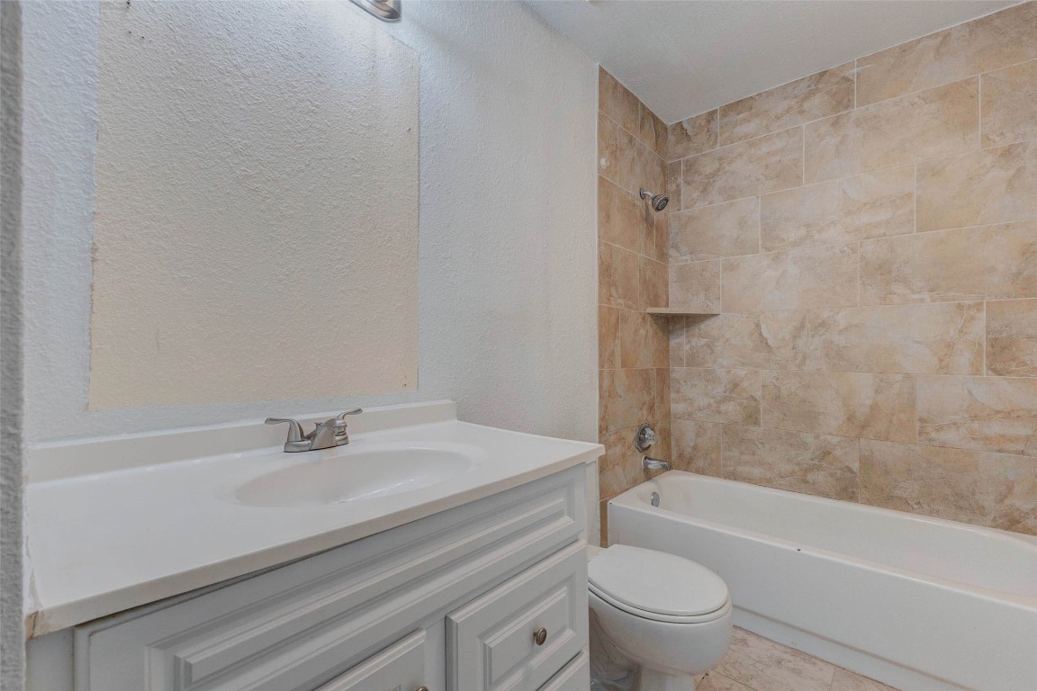 5210 Shirley Street Baytown, TX 77521 - Photo 25 of 31 a bathroom with a sink a toilet and a bathtub