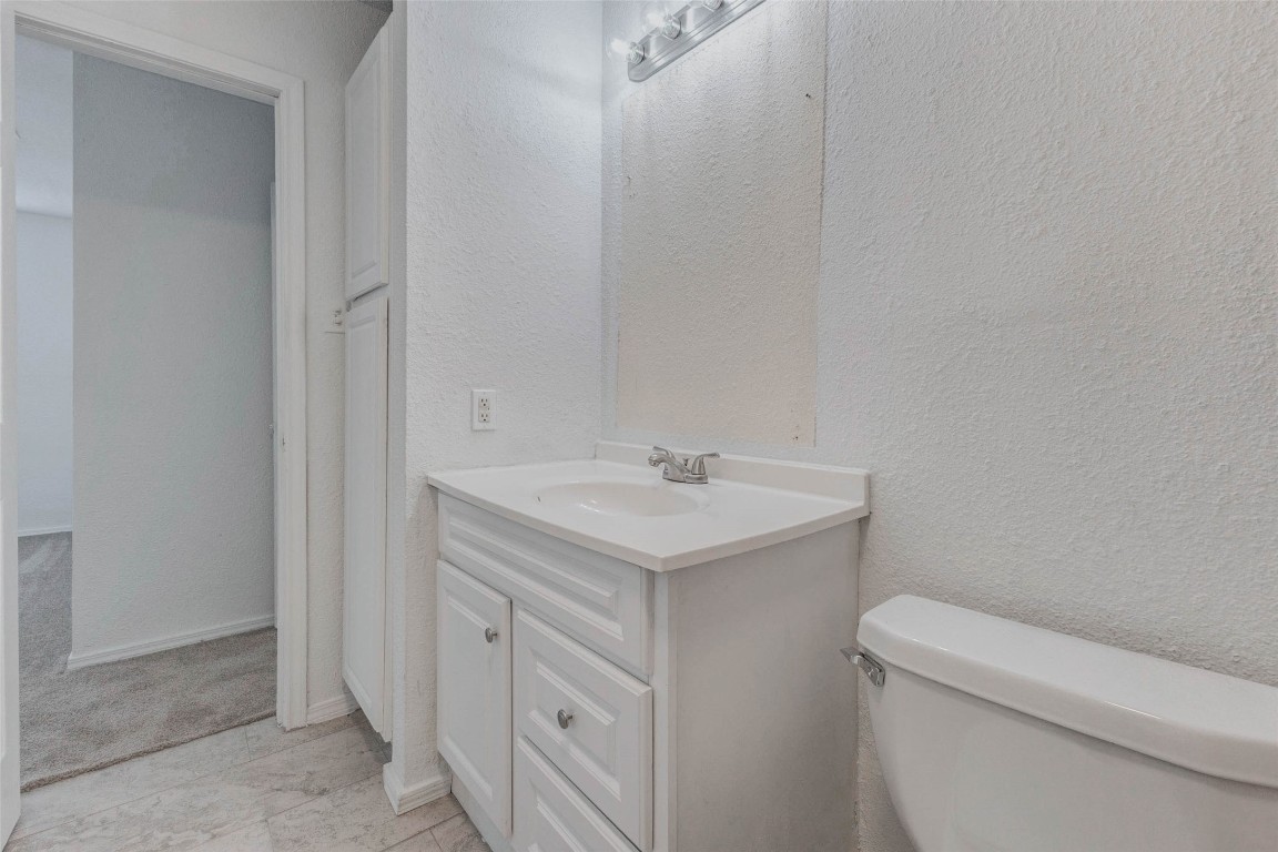 5210 Shirley Street Baytown, TX 77521 - Photo 26 of 31 a bathroom with a sink toilet and vanity