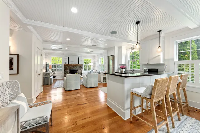 a kitchen with stainless steel appliances kitchen island granite countertop a table and chairs in it