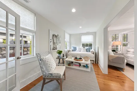 a bedroom with furniture and a window