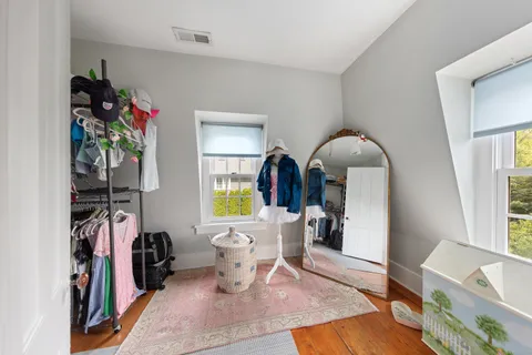 a living room with furniture a piano and a window