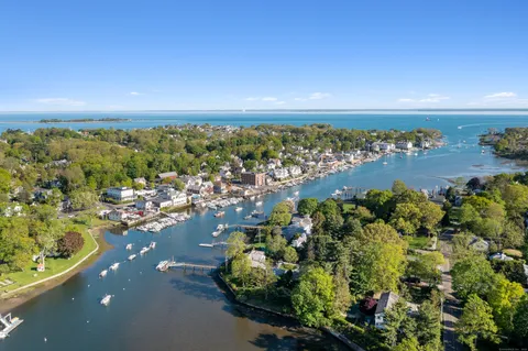an aerial view of a houses with a lake view