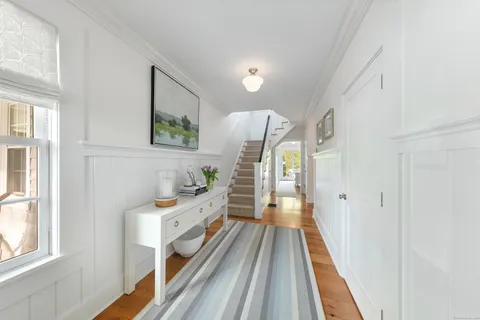 a view of a bedroom with wooden floor and furniture