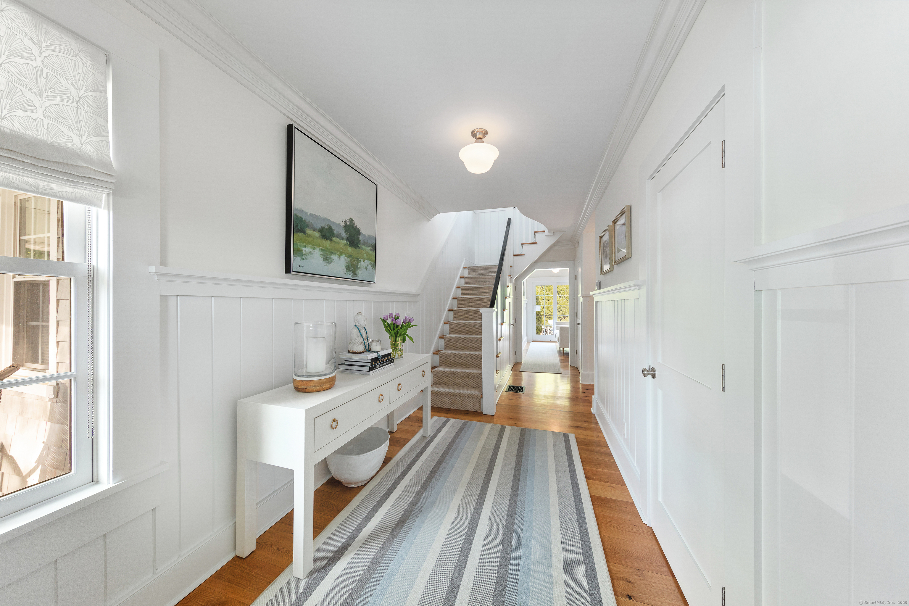168 Rowayton Avenue Norwalk, CT 06853 - Photo 3 of 27 a view of a bedroom with wooden floor and furniture