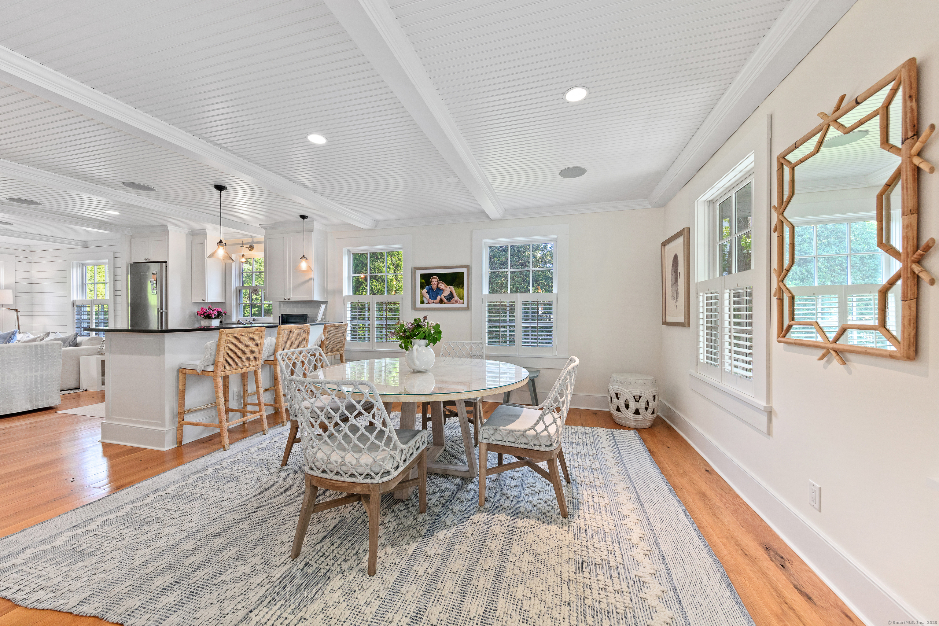 168 Rowayton Avenue Norwalk, CT 06853 - Photo 6 of 27 a dining room with wooden floor and large windows