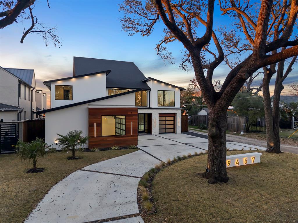 9457 Waterview Road Dallas, TX 75218 - Photo 5 of 25 Contemporary architectural design featuring a white stucco exterior with wood-finish paneling accents