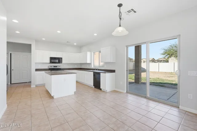 a view of a dining room with furniture and window