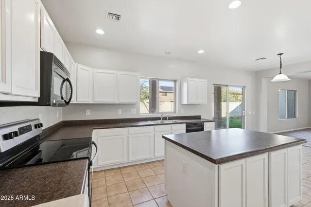 a kitchen with stainless steel appliances granite countertop a sink and a stove
