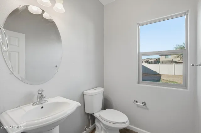 a kitchen with stainless steel appliances granite countertop a refrigerator a oven and white cabinets