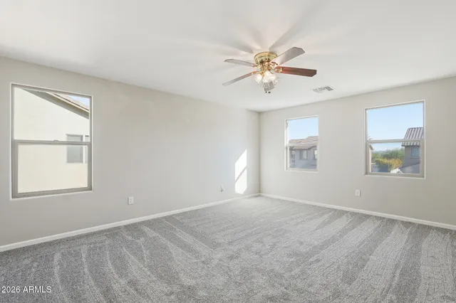 a bedroom with a bed table flowerpot and window