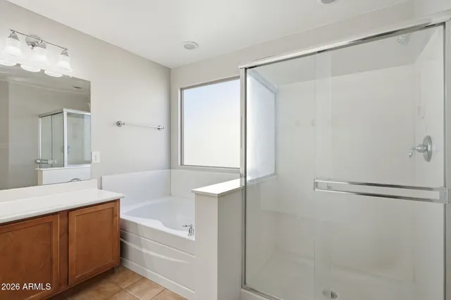 a large white kitchen with a sink and cabinets