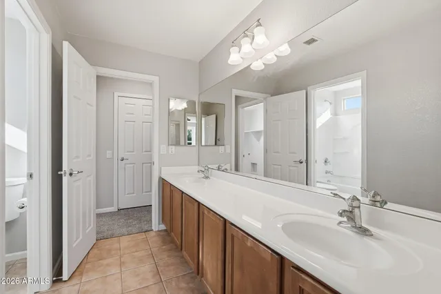 a bathroom with a tub sink and mirror