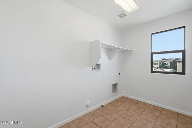 an empty room with a ceiling fan and carpet