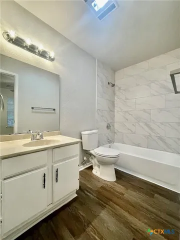 a bathroom with a toilet a sink and bathtub