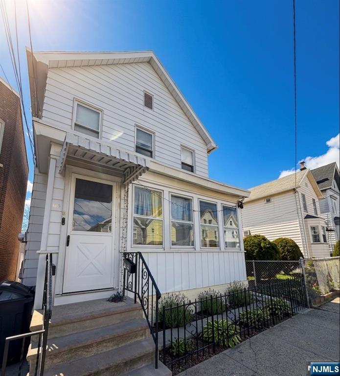 110 Tappan Street Kearny, NJ 07032 - Photo 1 of 13 a view of a house with wooden fence