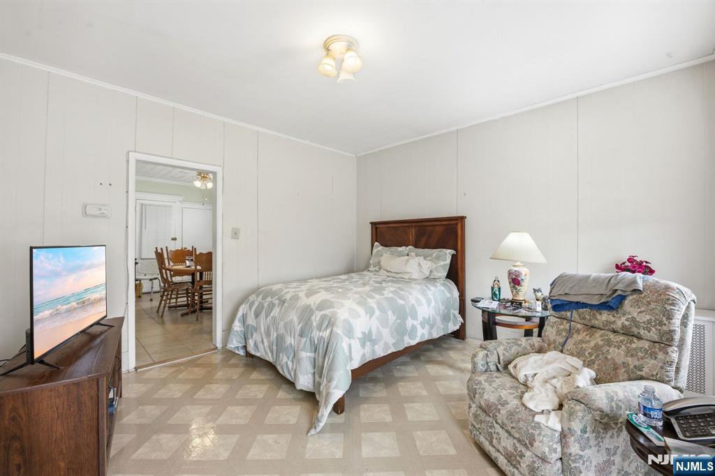 110 Tappan Street Kearny, NJ 07032 - Photo 5 of 13 a bedroom with bed and a tv