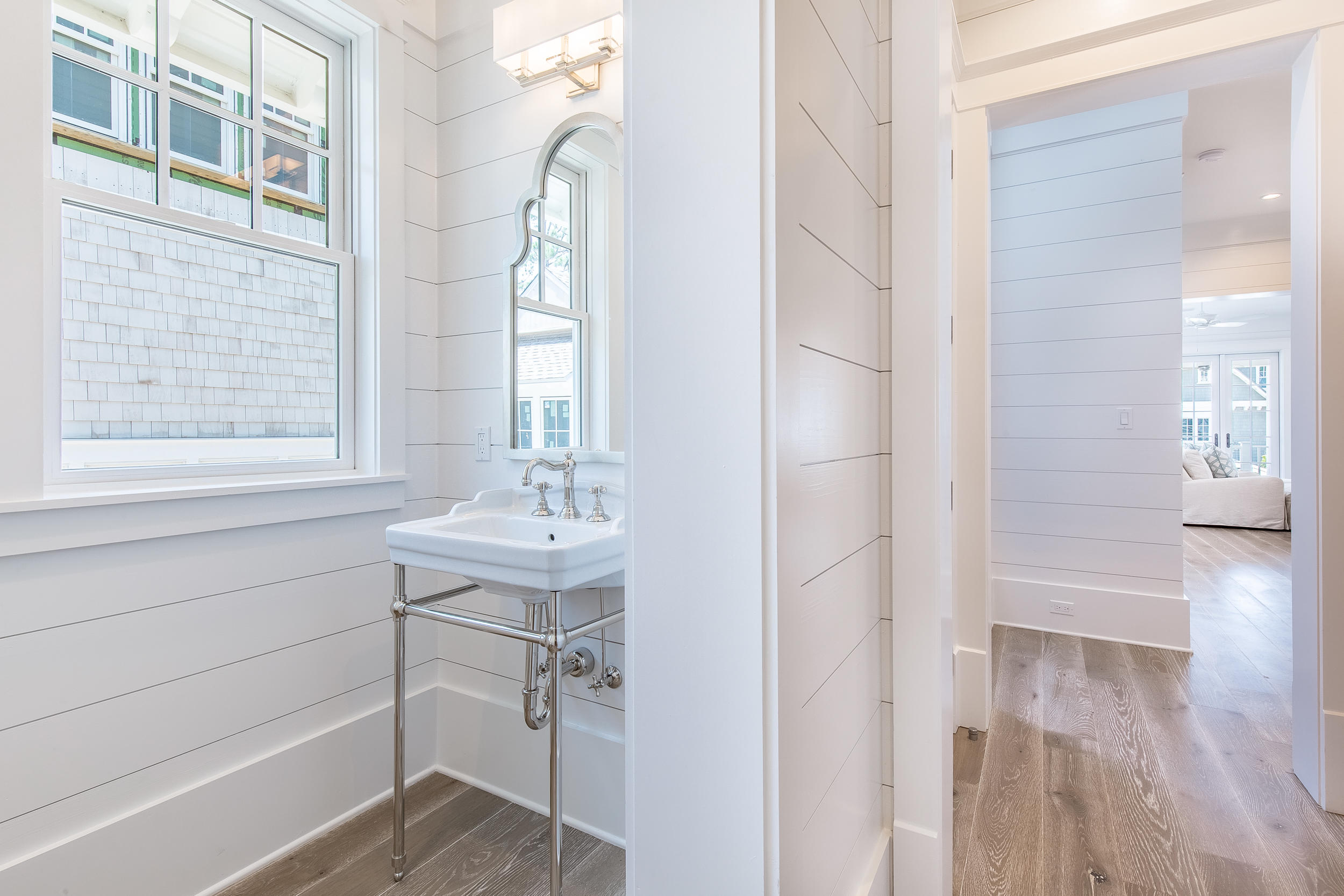 Lot 50 South Compass Point Way Watersound, FL 32461 - Photo 50 of 89 a bathroom with a sink a mirror and a shower