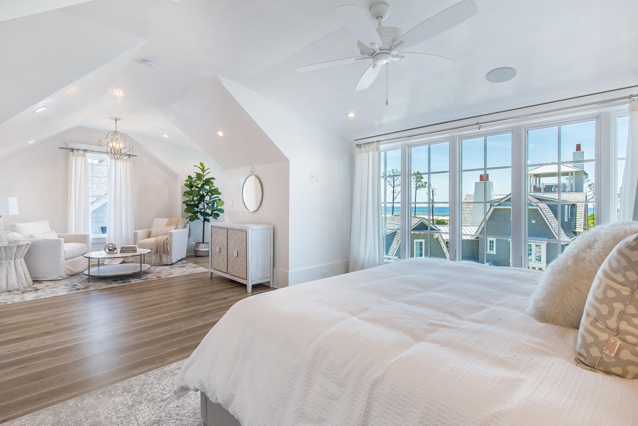 Lot 50 South Compass Point Way Watersound, FL 32461 - Photo 8 of 89 a spacious bedroom with a balcony a bed a couch and a large window with the outer view