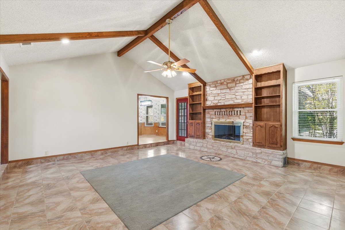 250 Hickory Drive Elgin, TX 78621 - Photo 9 of 37 a view of an empty room with a fireplace and a window