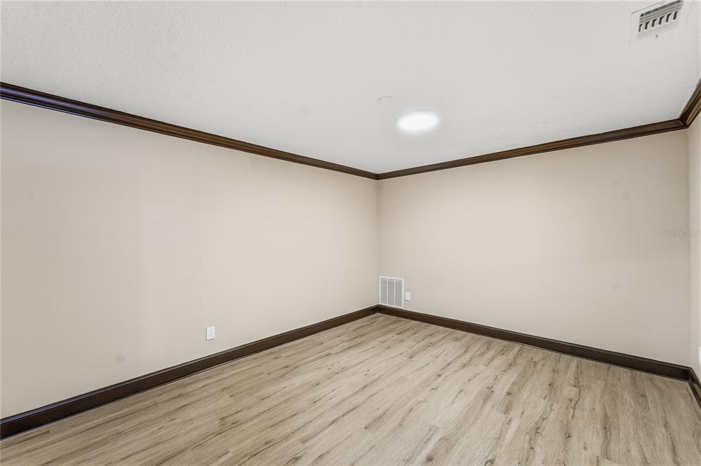 14728 Henson Road Orlando, FL 32832 - Photo 13 of 70 a view of an empty room with wooden floor