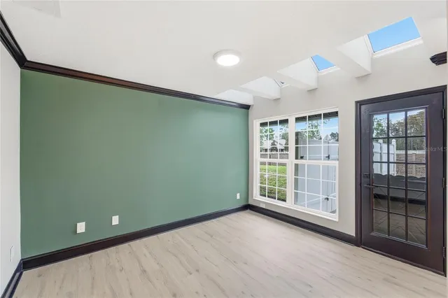 a kitchen with stainless steel appliances granite countertop a refrigerator a oven a sink with a countertop and chairs