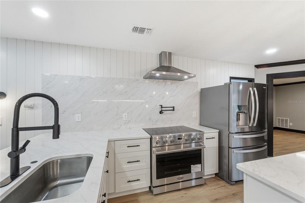 14728 Henson Road Orlando, FL 32832 - Photo 27 of 70 a kitchen with stainless steel appliances a sink and a refrigerator